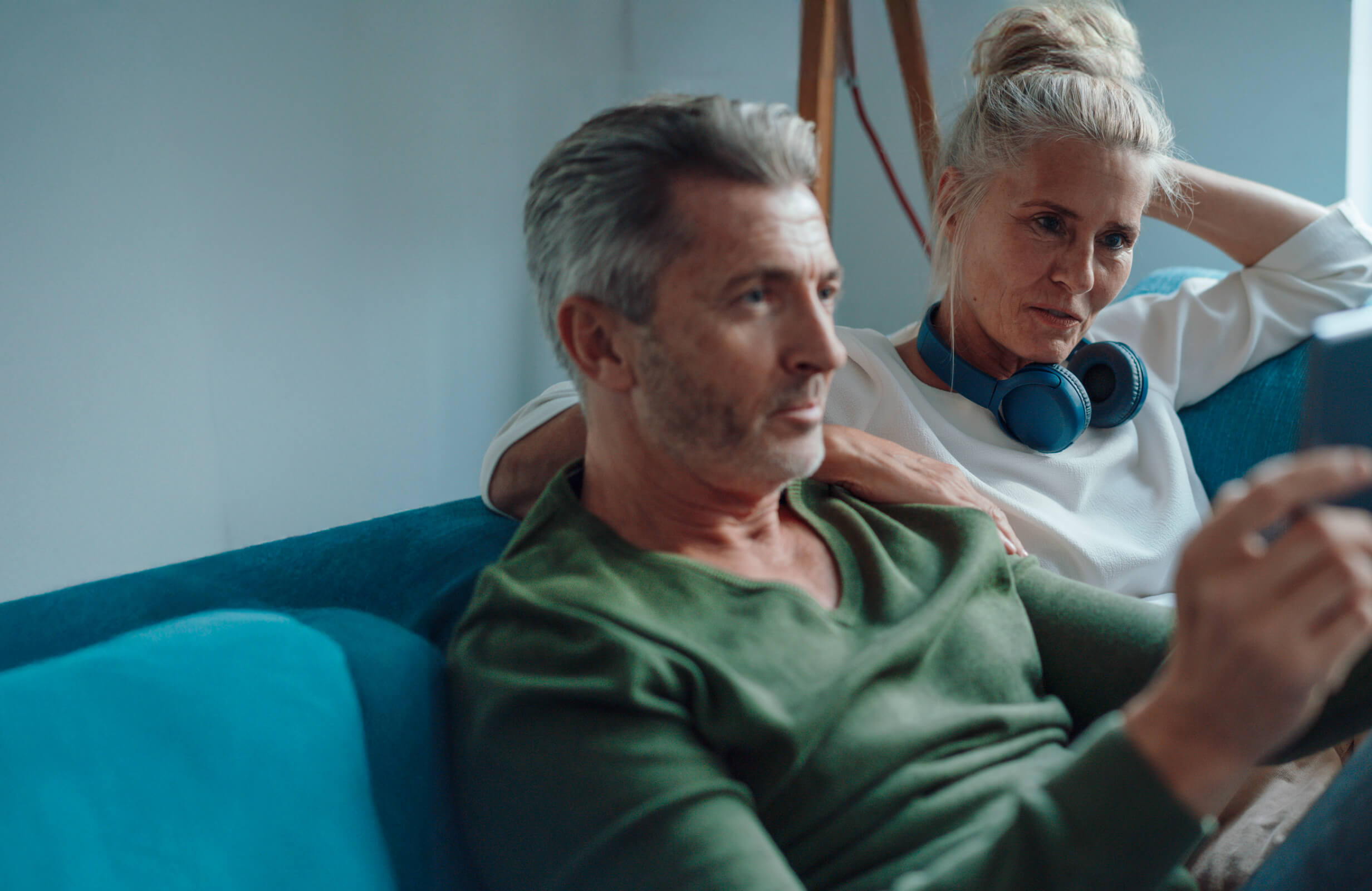 Couple sitting on a couch together. 