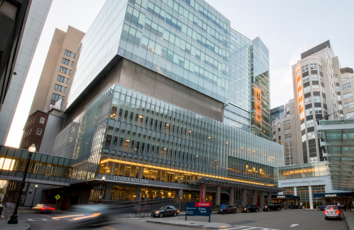 Wide shot of the exterior of the Mass General Hospital building and surrounding buildings. 